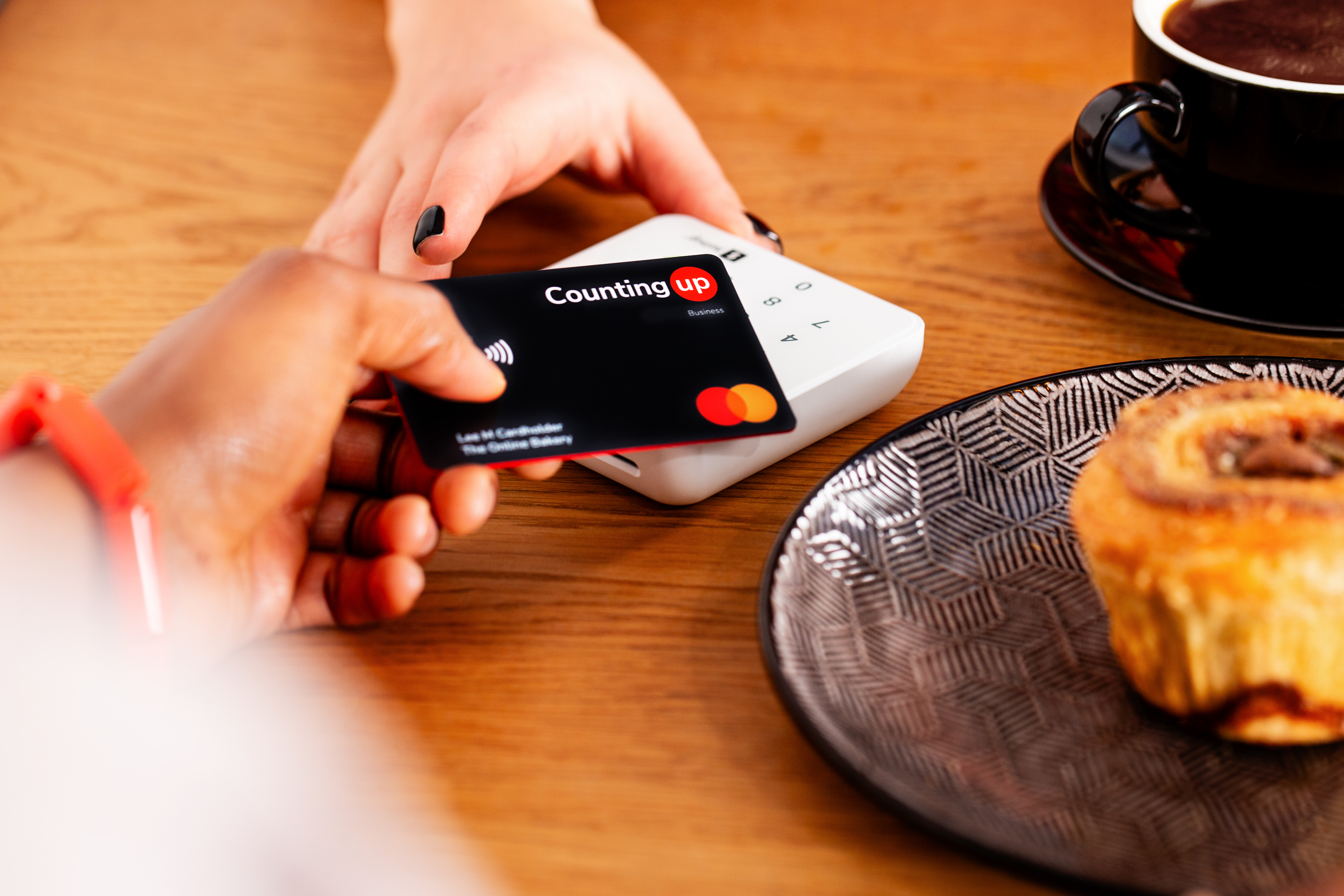 Customer paying for baked goods at cafe with Countingup card